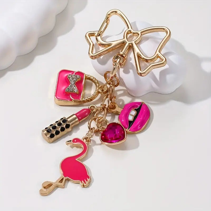 Llavero festivo de flamenco con labial rosa, corazón y lazo dorado: el regalo perfecto para el Día de la Mujer.